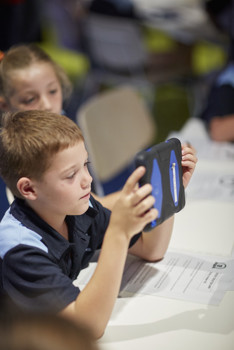 Student holding up iPad