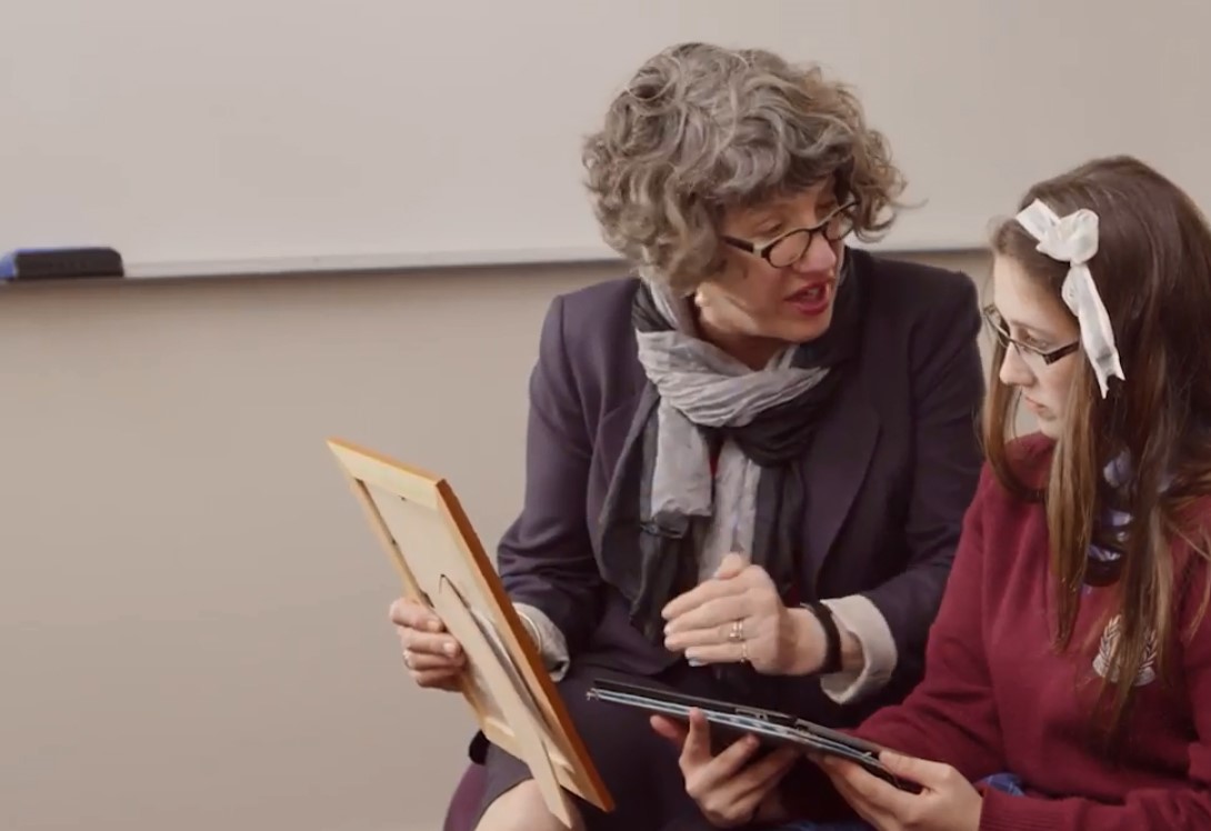 Teacher guiding student to use iPad