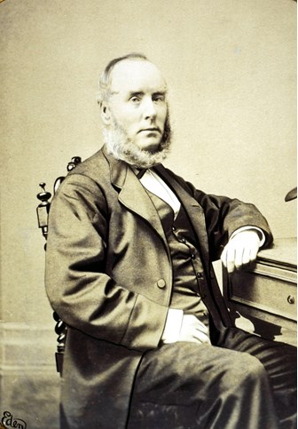 John Mullaly at a desk circa 1870s 