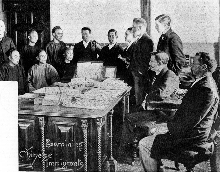 White men checking Chinese immigrant's paperwork