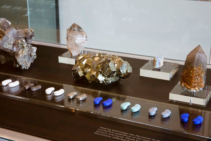 hearing aids and minerals in a museum display