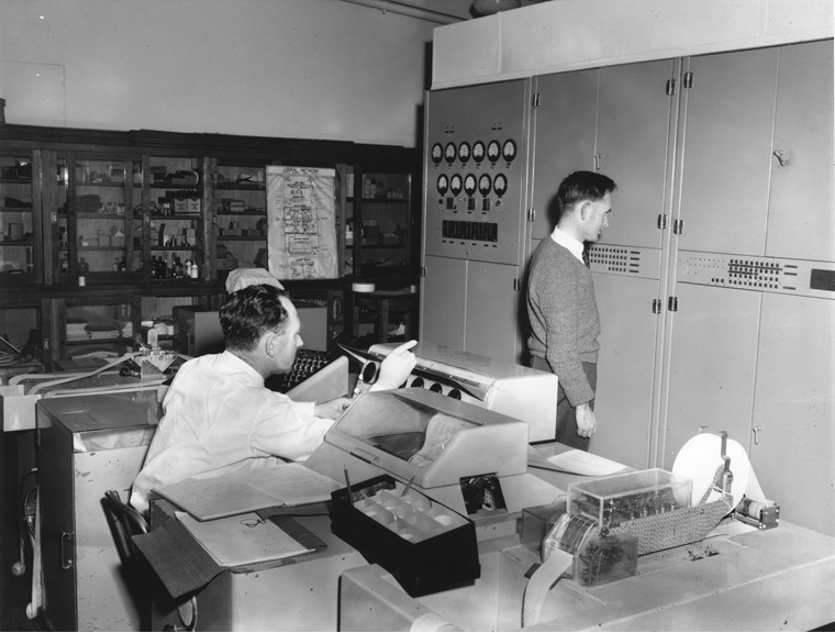 Two men operating a first-generation computer