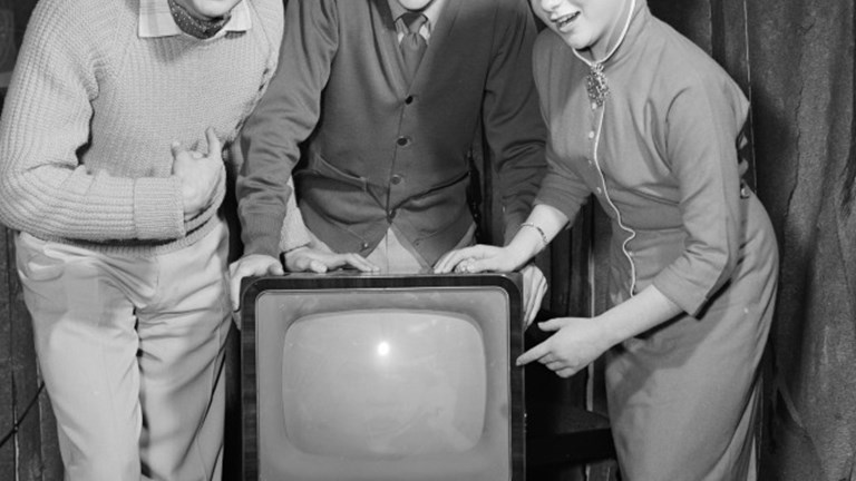 Woman & Two Men standing next to a Television Set, 1958