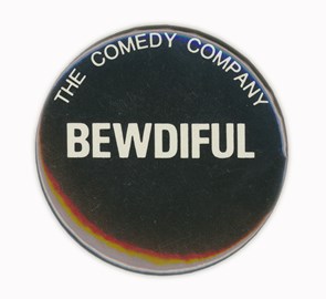 Round badge saying “Bewdiful, The Comedy Company”
