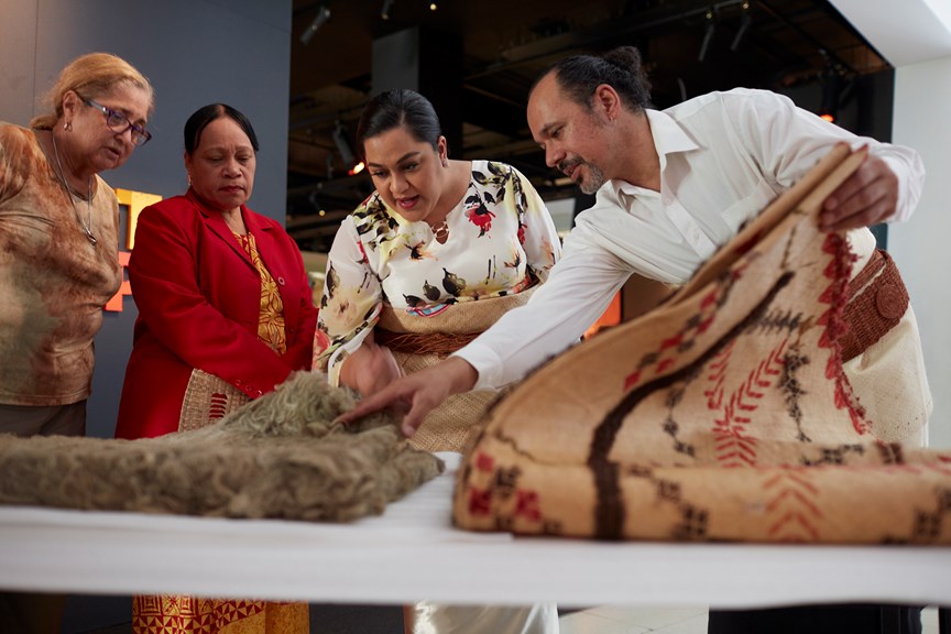 Sione Napi Francis showing Princess Saloe items from the Museum’s collection, including a Rotuman Fine mat, during her visit to Melbourne Museum, 2018.
