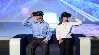 Two students using virtual reality googles to experience a road trip from the past to the future of travel in Victoria. 