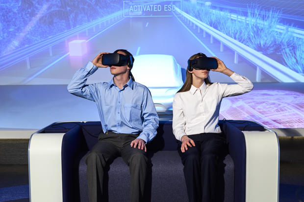 Two students using virtual reality googles to experience a road trip from the past to the future of travel in Victoria. 