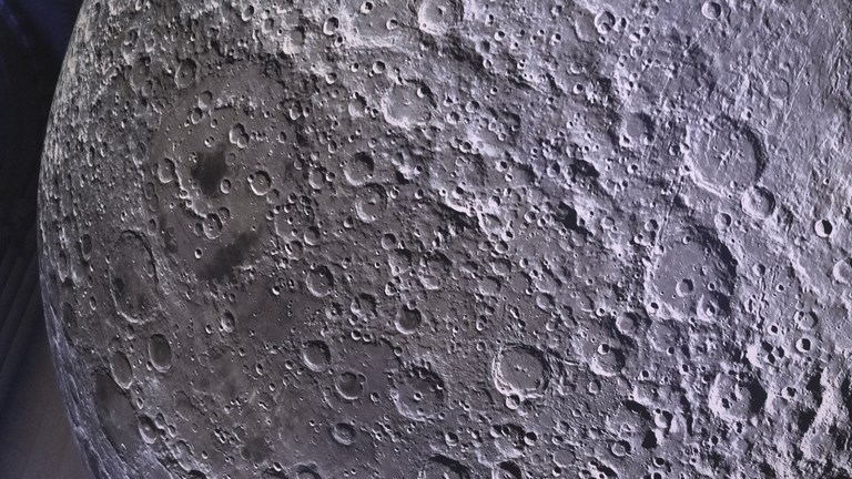 A close up view of the moon sculpture, showing craters and other geological features present on the moon surface.