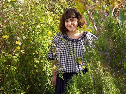 Julia Busuttil Nishimura in her garden surrounded by leaves