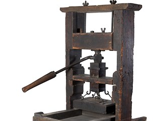 Printing press; a wooden standing mechanism with a movable tray to hold type held in a frame, with manually operated screw mechanism.