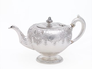 Ornate silver teapot, large, with impressed decoration and engraved inscription.