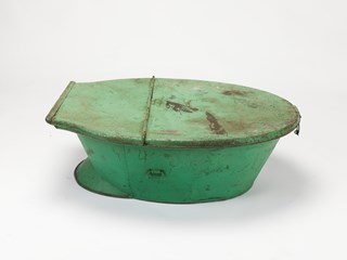 Green, painted metal travel bath with lid brought to Australia by the Davies family, who migrated during the mid-nineteenth century. 