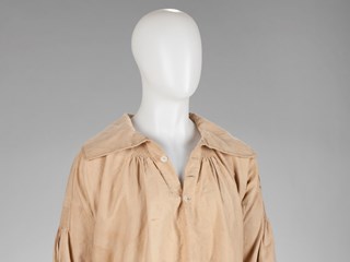 Farm worker's smock (or Slop). Loose over-garment, covering the knees, handmade from drabbet (twilled linen) khaki coloured, some rust spots.