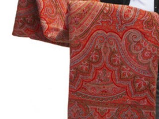 Finely woven twill tapestry technique wool shawl in 'Paisley' design. Colour palette red, orange, black, white and blue. Fringed edging.