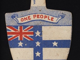 Cardboard in the shape of a shovel. The obverse printed in red and blue on a white ground with an image of the NSW Ensign and the slogan. The election details are printed on the reverse in black ink.