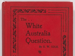 Red-covered book 'The White Australia Question', written in Melbourne by Edward William Cole, and published by the Cole's Book Arcade in 1903.
