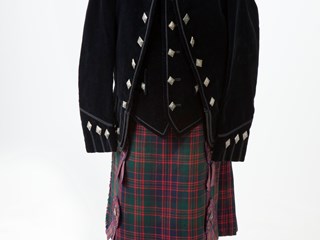 Child's costume consisting of: 1: Tartan ribbons; 2: Tartan kilt in McDonald tartan, with silk lining around waist, four ribbon rosettes held onto the front of the kilt by four diamond-shaped silver buttons with a thistle emblem on each.