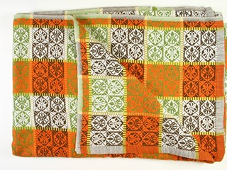 Orange, brown and green cotton bedspread with chequer pattern.