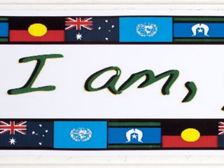 White sticker on white backing paper. Slogan is in the centre in green, "I am, you are", and above and below this are the Torres Strait, Aboriginal, Australian and United Nations flags. Just below the slogan in red is: "myspace.com/ozstickers".