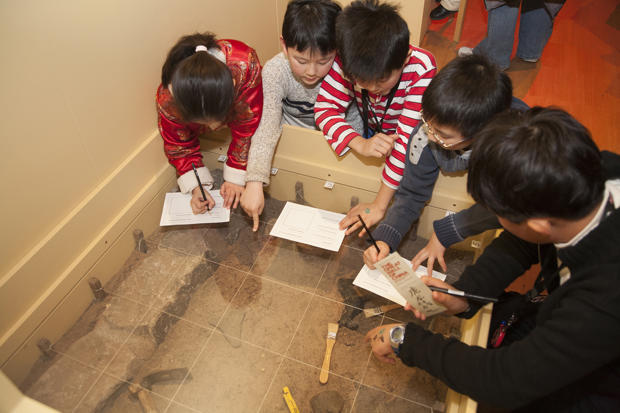 Children participating in an archaeological activity in the Great Wall of China Exhibition during the 2007 Winter School Holiday Program at Melbourne Museum.