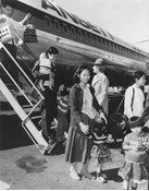 Vietnamese refugees disembarking an Ansett plane in Canberra, 1979