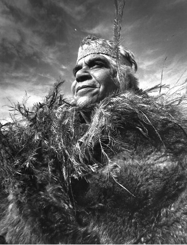 Winnie Quagliotti, dressed in a cloak of possum skins with a collar of emu feathers