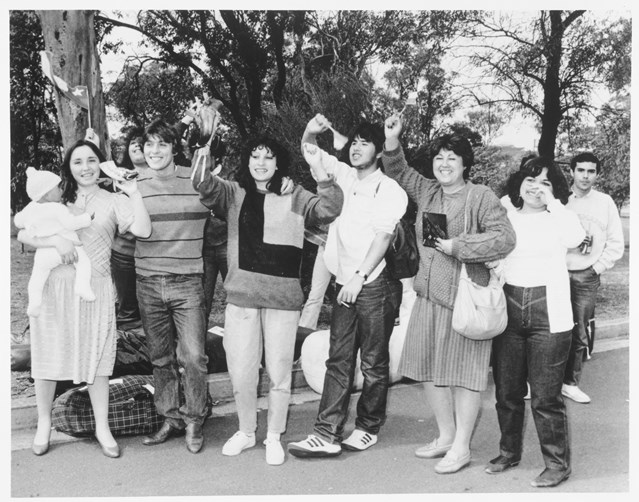 Eight Chilean-Australians provide a standing, roadside welcome to a group (out of shot) of 32 new Chilean migrants