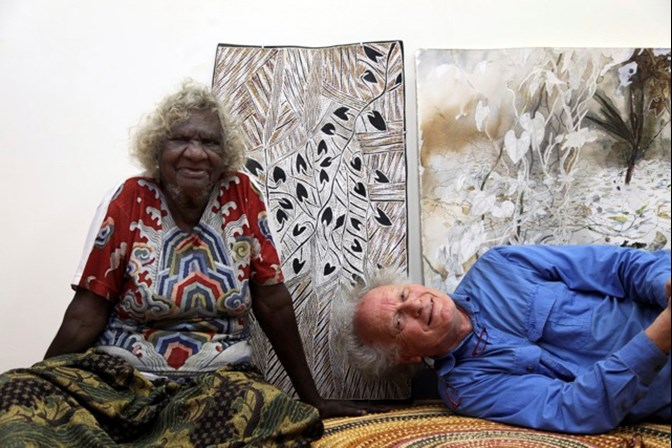 Artists Mulkuṉ​ Wirrpanda and John Wolseley pose in front of their work.