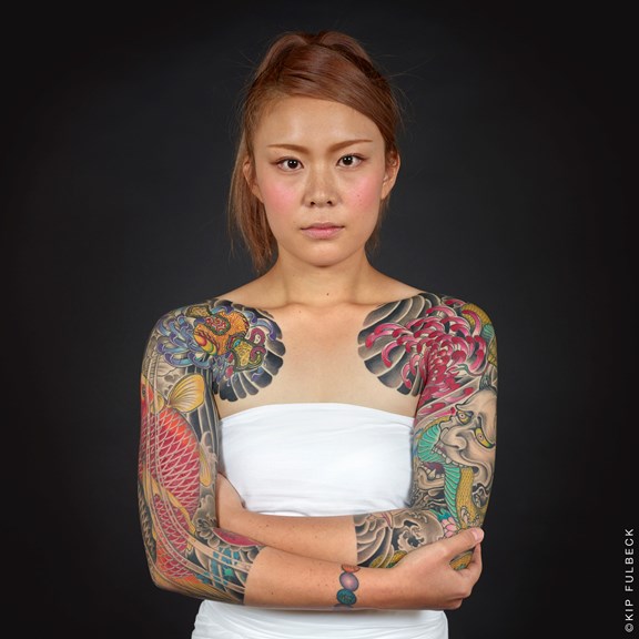 Woman with tattoos on her arms