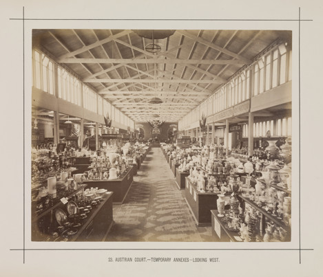Interior view of a temporary annexe to the Royal Exhibition Building showing the Austrian display during the Melbourne International Exhibition of 1880. Caption reads: 23. Austrian Court.- Temporary Annexes.- Looking West