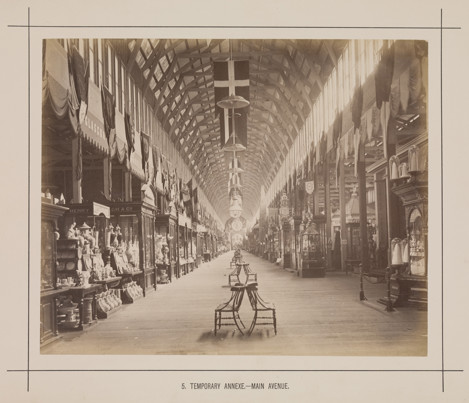 Main avenue of the temporary annexe to the Royal Exhibition Building during the Melbourne International Exhibition of 1880. Caption reads: 5. Temporary Annexe.- Main Avenue