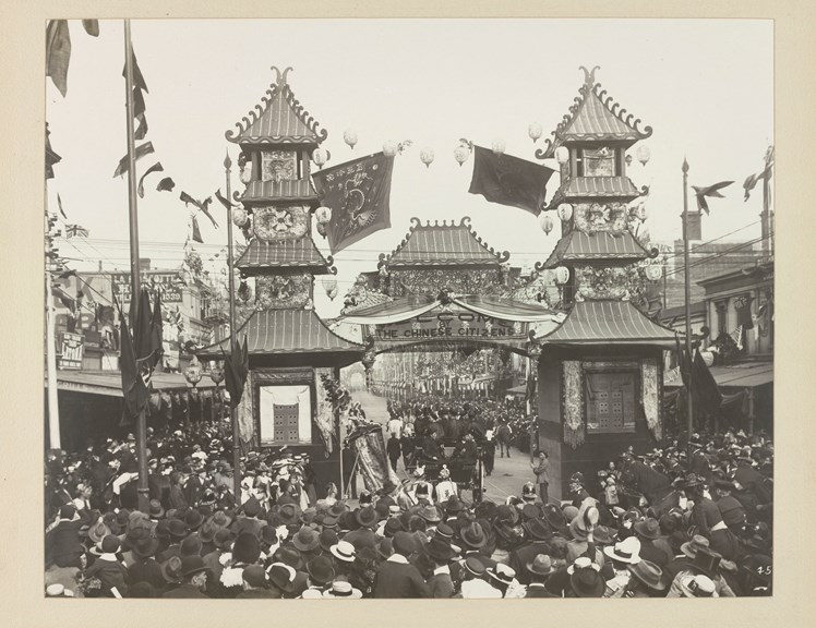 Crowd of people in front of a Chinese arch