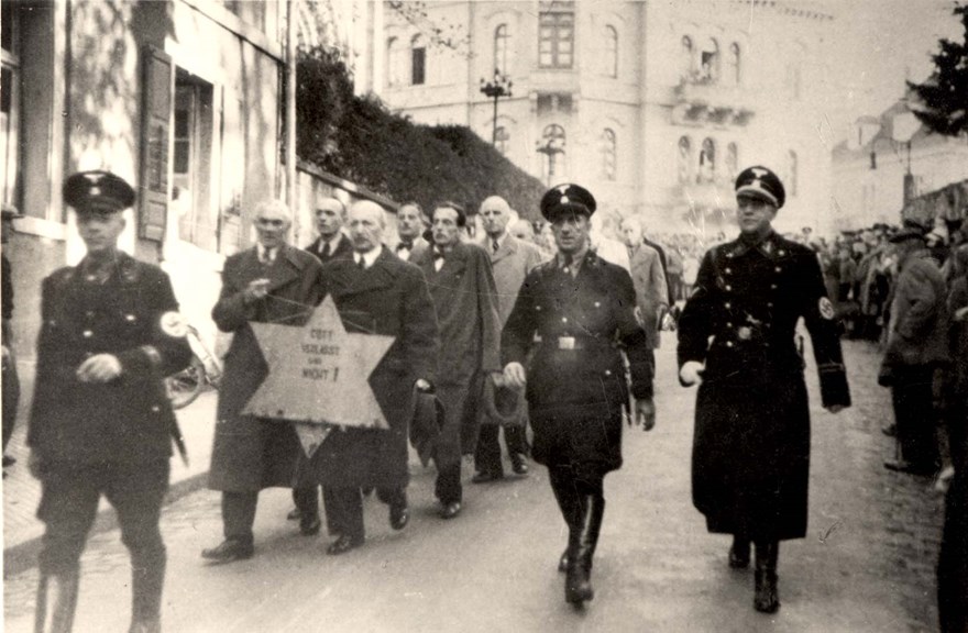 Nazi soldiers rounding up Jewish men during Kristellnacht, Germany, 1938