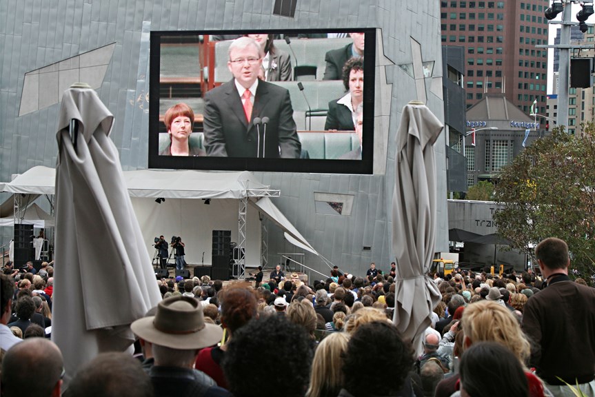 Screen showing Kevin Rudd in a public space
