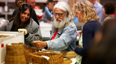 Yulendj members Lisa Jones and Elder Larry Walsh talk with curator Rosemary Wrench in the First Peoples collection store.