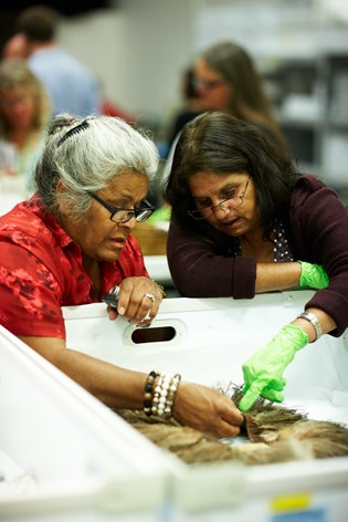 Elder Esther Kirby and Titta Secombe examine an emu feather skirt during a Yulendj workshop, April 2012.