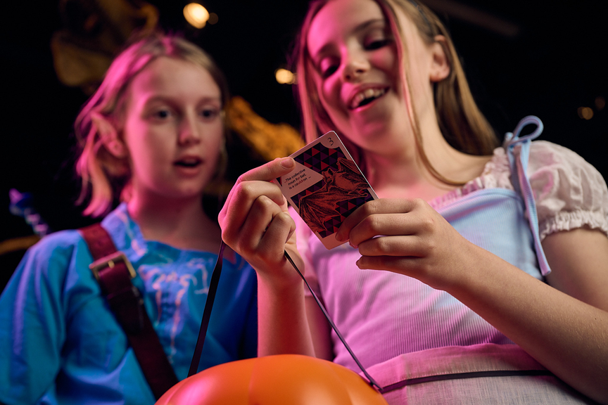 Two children collecting cards.