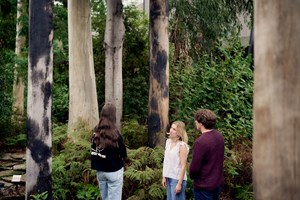 Three people in the Forest Gallery at Melbourne Museum