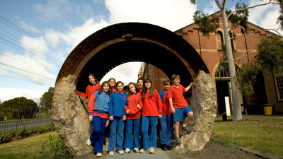students stand in an old tunnelling shield  