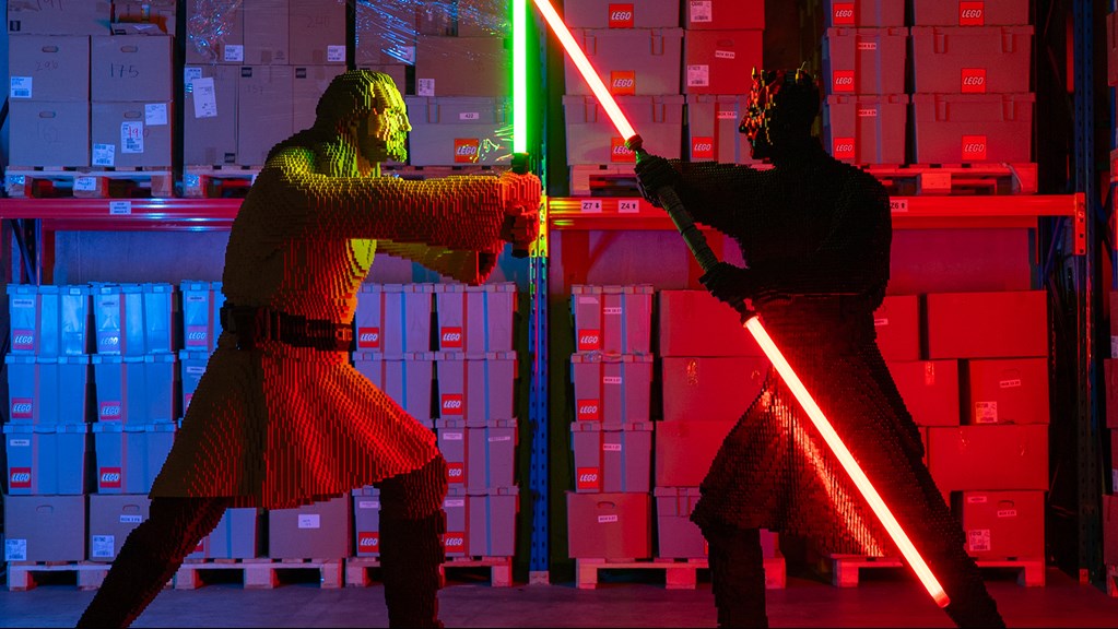 Qui-Gon Jinn the Jedi master and the Darth Maul the Sith Lord crossing lightsabers in a duel at LEGO for LEGO® Star Wars: The Exhibition at Melbourne Museum.
