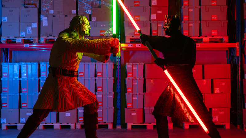 Qui-Gon Jinn the Jedi master and the Darth Maul the Sith Lord crossing lightsabers in a duel at LEGO for LEGO® Star Wars: The Exhibition at Melbourne Museum.