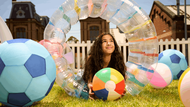 Children playing with inflatable balls and toys on the Sceinceworks Arena during Thursday Family Night.