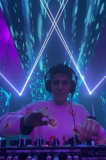 DJ Dub Darko djing with lights and lasers in the background.