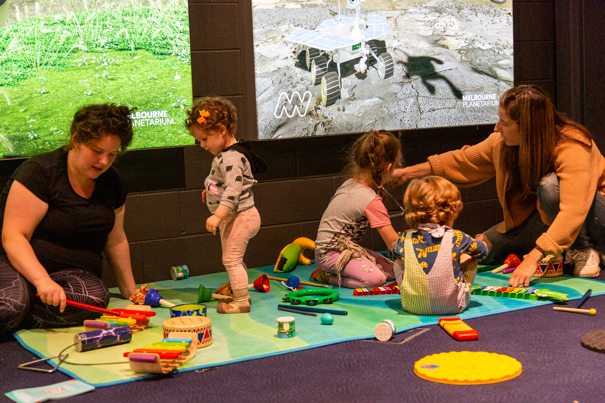 amily at the Tiny Tinkerers activity in the Planetarium Foyer during the Little Kid's Day In program at Scienceworks.