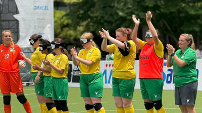 Members of The Bilbies, Australian Women’s Blind Football clapping together on the field.