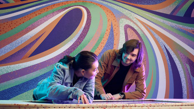 Two people use an interactive display inside Our Wonderous Planet exhibition at Melbourne Museum.