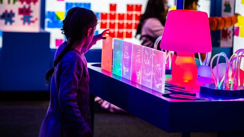 A child playing with light at the exhibition, Illuminate.