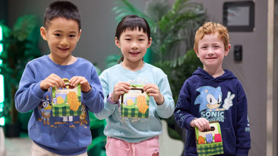 Three children holding their boxed potted seed they have made during Seed Stories workshop at Melbourne Museum.
