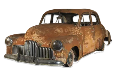 The shell of an old holden car that has been damaged by fire.