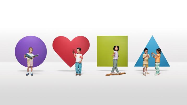 A different child stands in front of a circle, square, hear and triangle.